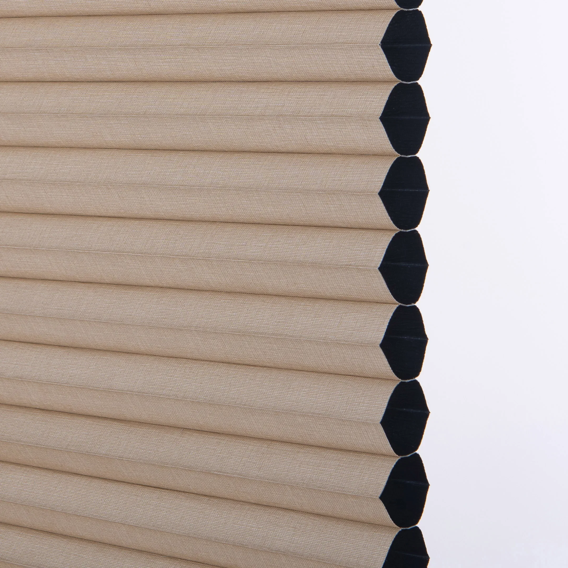 Side profile of a sand-coloured honeycomb fabric showing its hexagonal cells